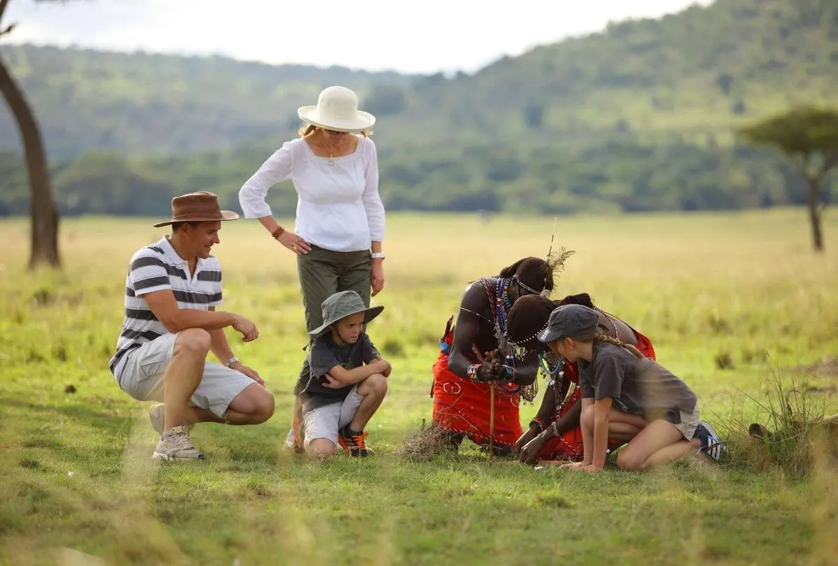 Happy family on an African safari watching elephants together