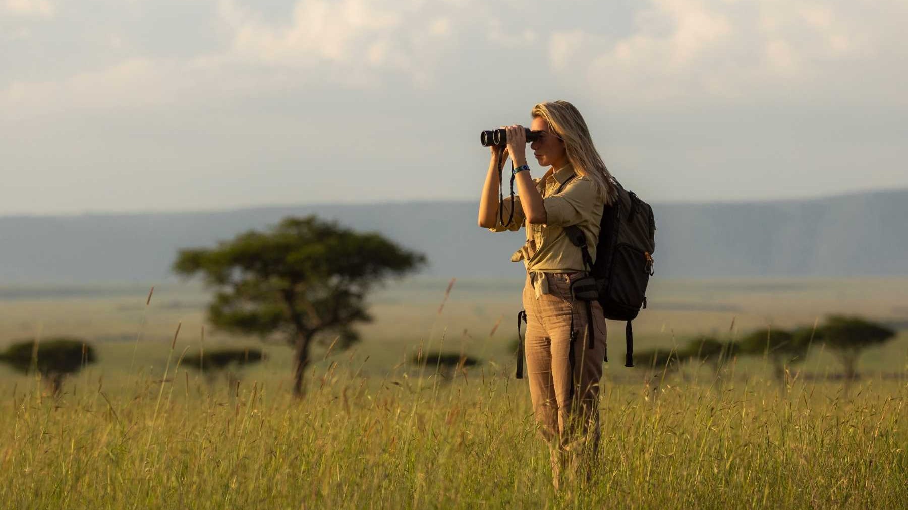 Solo traveller on African safari adventure photographing wildlife